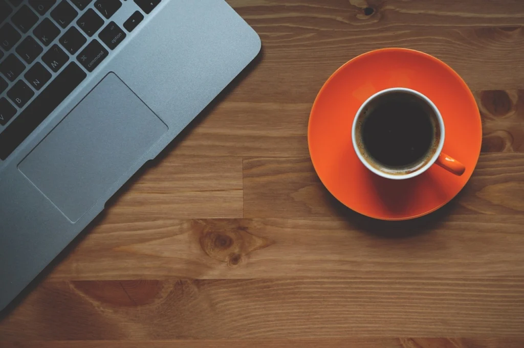 Workspace with laptop and coffee showing productivity and automation tools that save time