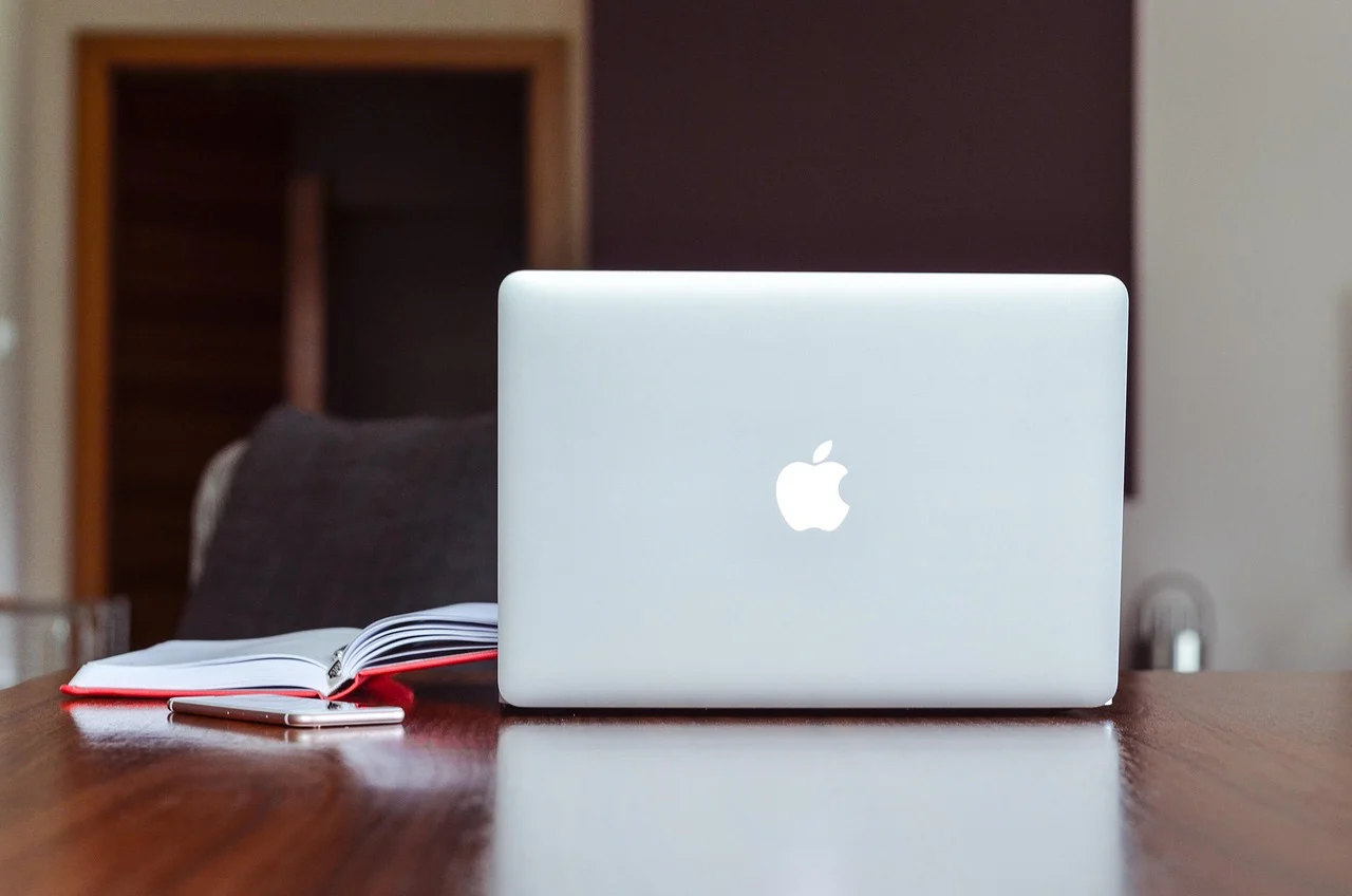Workspace with laptop and notebook on desk