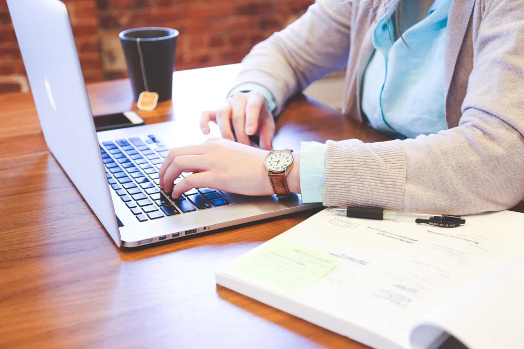 Hands typing on a keyboard as a screen shows workflow automation
