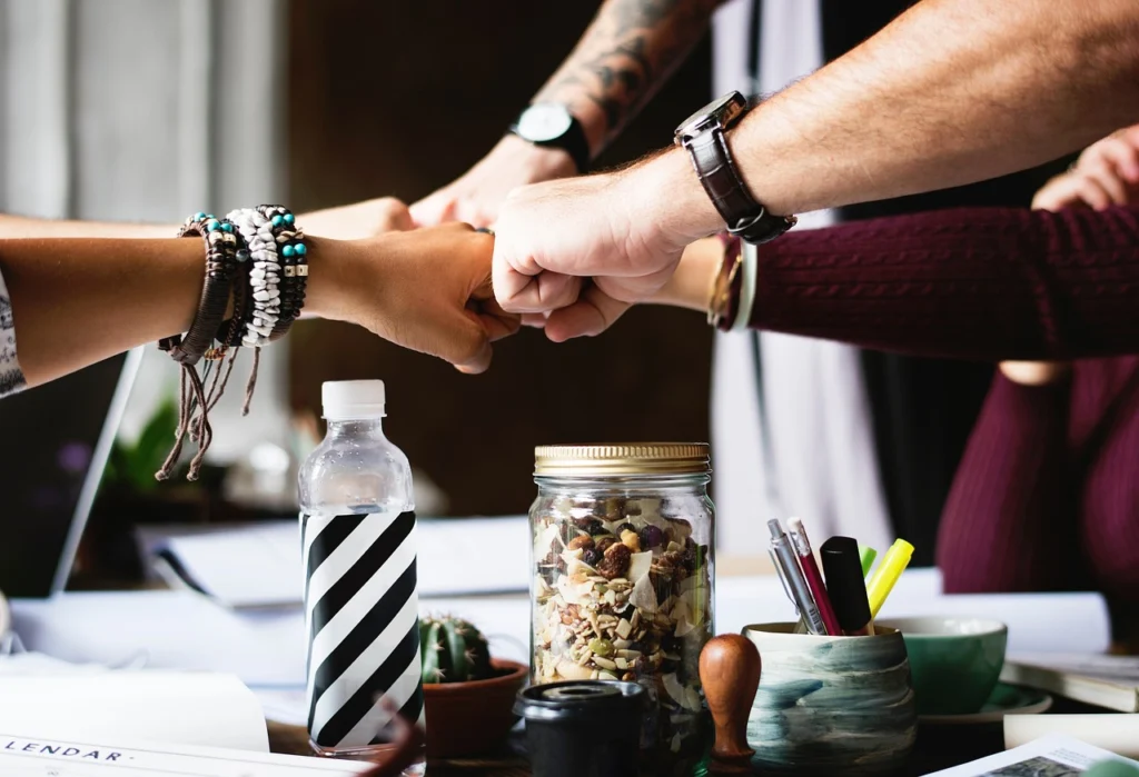 Business team collaborating around a table with laptops and notes discussing automation tools
