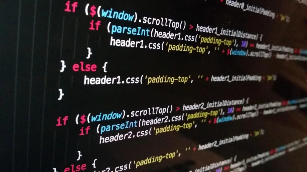 Developer writing code on a dual monitor setup, illustrating API-based AI integration